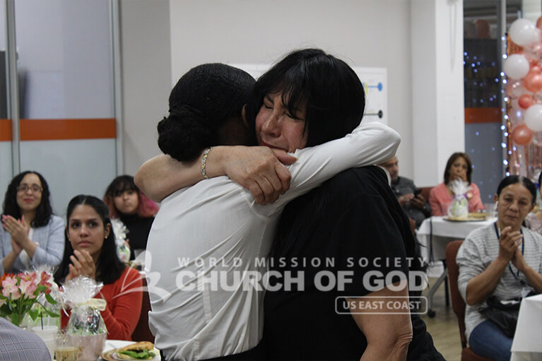 Mother and child embracing each other on Mother's Day 2019 at the Church of God.